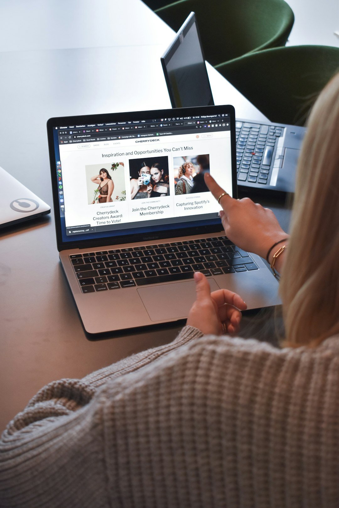 Finnish woman media producer monitoring live video feed on laptop